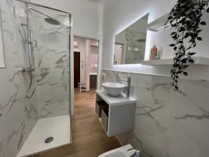 a white bathroom with a sink and a shower at Comfort Zone in Mestre