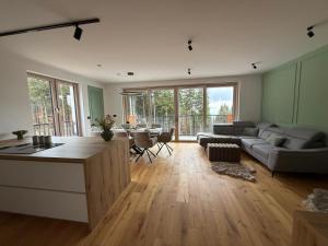 a living room with a couch and a table at Apartment Moné - Kope in Slovenj Gradec