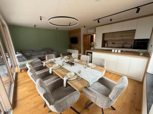a dining room with a table and chairs at Apartment Moné - Kope in Slovenj Gradec