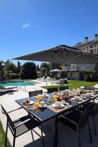 a table with plates of food on it with an umbrella at Villa Monaco in Mosciano SantʼAngelo +28 photos