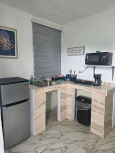 a kitchen with a sink and a counter at Relax en el pueblo 2 in Fajardo