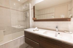 a white bathroom with a sink and a shower at Hôtel de la Pointe du Grouin in Cancale +53 photos