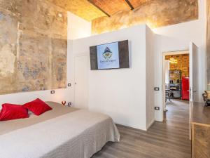 a bedroom with a bed and a painting on the wall at Apartment The Knight's Rest by Interhome in Bibbona