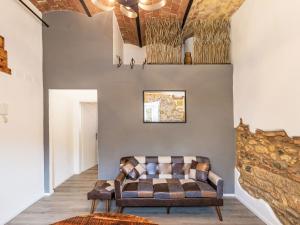 a living room with a couch against a wall at Apartment The Knight's Rest by Interhome in Bibbona