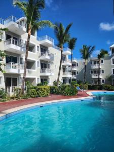a swimming pool in front of a apartment building at beautiful vacation Sol Caribe in Punta Cana