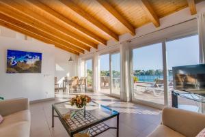 a living room with a view of the ocean at Es Port penthouse in Santanyi