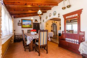 a dining room with a table and chairs and a bedroom at Ses Rodes in Felanitx