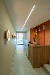 a hallway with a reception desk in a building at Bruma Verde Casa Hotel in Medellín