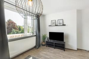 a living room with a television and a window at Ferienwohnung Jule in Arnsberg