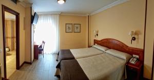 Postel nebo postele na pokoji v ubytování Hotel Alisi
