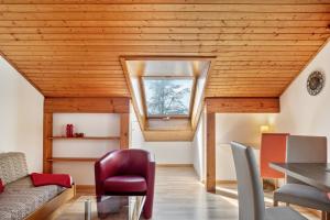 a room with a wooden ceiling with a window at Gästehaus Gaby in Bad Bellingen