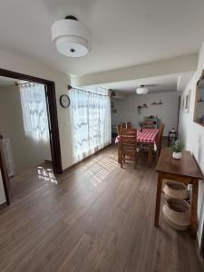 a living room with a table and a dining room at Spacious house just steps from the cathedral in Morelia