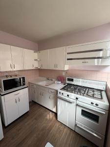 a kitchen with white cabinets and a stove top oven at Spacious house just steps from the cathedral in Morelia +17 photos