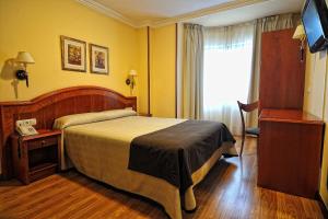 Postel nebo postele na pokoji v ubytování Hotel Alisi