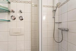 a bathroom with a shower with a shower head at Fewo Ricken am Kurpark in Willingen +17 photos