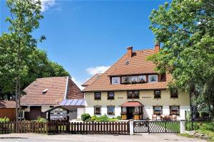 a large house with a fence in front of it at Ferienwohnung Meierhof, 38qm in Sankt Märgen