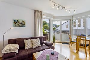 a living room with a couch and a table at Fewo Ricken am Kurpark in Willingen