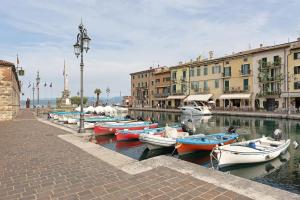 a group of boats are docked in a canal at B and B 7 Camini in Verona