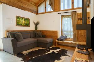 a living room with a couch and a window at Luxury Chalet Giulia in Torcegno
