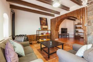 a living room with a couch and a table at Masia Alt in Olerdola