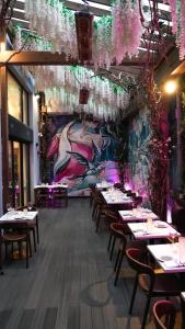 a restaurant with tables and chairs and a mural at Concorde Hotel New York in New York
