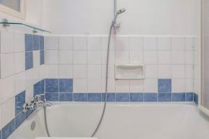 a bathroom with a bath tub with a shower at Ferienhaus Fingerhut in Eggen +22 photos