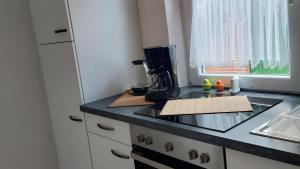 a kitchen with a counter top with a coffee maker at Ferienwohnung Schmidt in Krummhörn