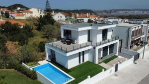 an aerial view of a house with a swimming pool at Villa Atlantic View in Salir de Porto