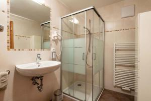 a bathroom with a sink and a shower at Huberhof App Golden Delicious in Feldthurns +32 photos