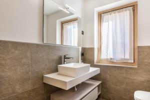 a bathroom with a sink and a mirror at Condominio Lucia 7 Pinzolo in Pinzolo +16 photos