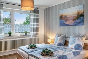a bedroom with a bed with two plants on it at Dat Jollenhuus in Ihlow