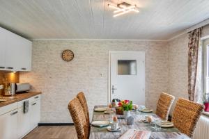 a kitchen and dining room with a table and chairs at Dat Jollenhuus in Ihlow +23 photos
