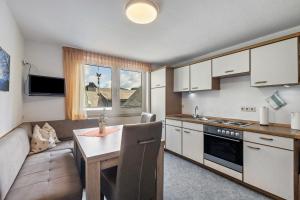 a kitchen and living room with a couch and a table at Ferienwohnung Hacke in Schmallenberg