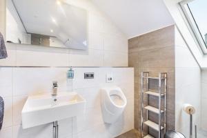 a bathroom with a sink and a toilet at Ferienwohnung Zur Henne in Weinbach +14 photos