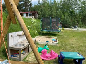 a playground with a play equipment in a yard at Między Wodami - domki na Mazurach in Mikołajki