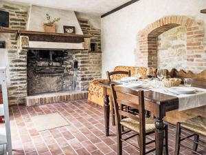 a dining room with a table and a fireplace at Apartment Cotoneaster by Interhome in Perugia