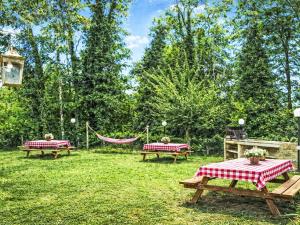 two picnic tables and a hammock in a yard at Apartment Cotoneaster by Interhome in Perugia
