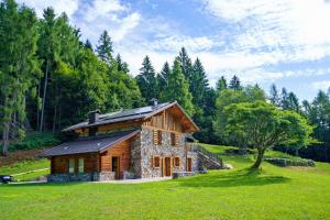 a log cabin in the middle of a field at Luxury Chalet Giulia in Torcegno