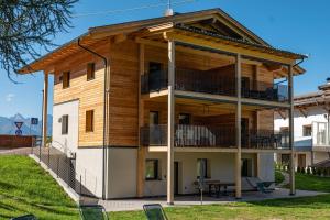 a wooden house with a gambrel roof at Ferienwohnung Kratzberg Edelweiss in Avelengo +8 photos