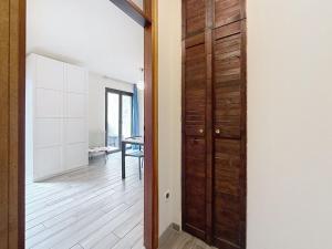 a room with a wooden door and a hallway at Apartment Marmolada-13 by Interhome in Alba di Canazei