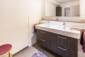 a bathroom with a sink and a mirror at Ferienwohnungen Haus Birgit in Günzgen +36 photos
