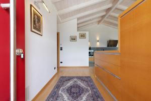 a hallway with a red door and a rug at Casa-lago suite 55 in Brenzone sul Garda