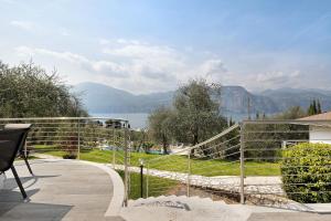 a balcony with a view of the water and mountains at Casa-lago suite 55 in Brenzone sul Garda