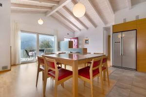 a kitchen with a dining room table and chairs at Casa-lago suite 55 in Brenzone sul Garda