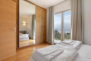 a bedroom with a bed and a large mirror at Casa-lago suite 55 in Brenzone sul Garda