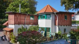 a house with a tiled roof at Hotel Buchenpark in Bansin