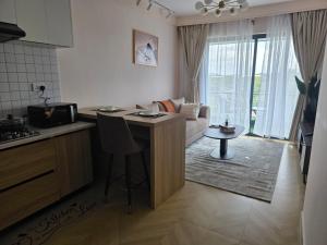 a kitchen and living room with a couch and a table at Ideal homes in Gatunga