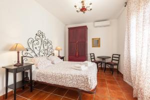a bedroom with a bed and a table and chairs at Masia Alt in Olerdola +23 photos