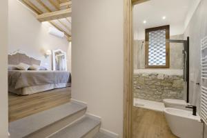 a bathroom with a sink and a bed in a room at Bellavista Cottage in Barberino di Mugello +40 photos