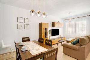 a living room with a table and a couch at Las Velas 37 in Meloneras